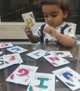 a child playing with flashcards on a table